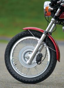 close up of the front wheel of a red motorcycle
